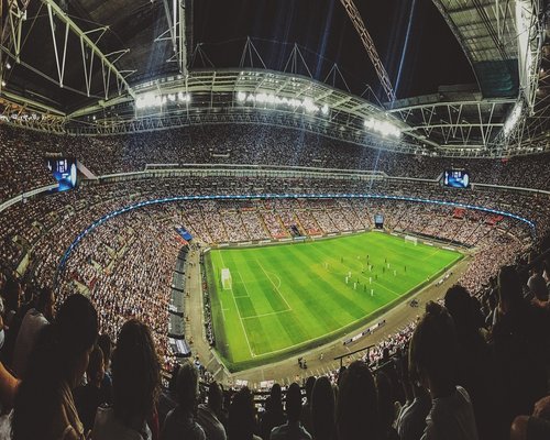 Large screen displaying esports event to audience