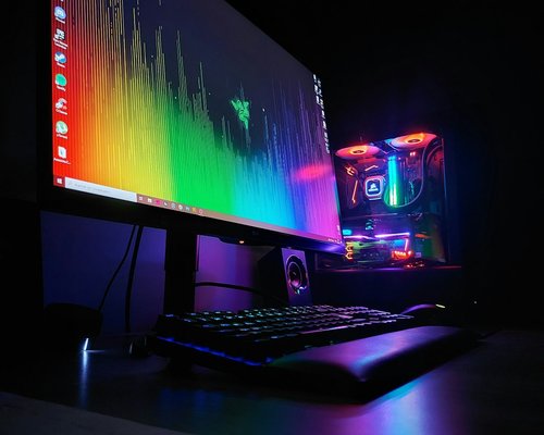 High-end PC gaming setup with glowing keyboard